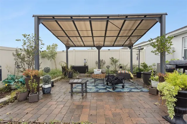 a view of a chair and tables in the backyard of a house