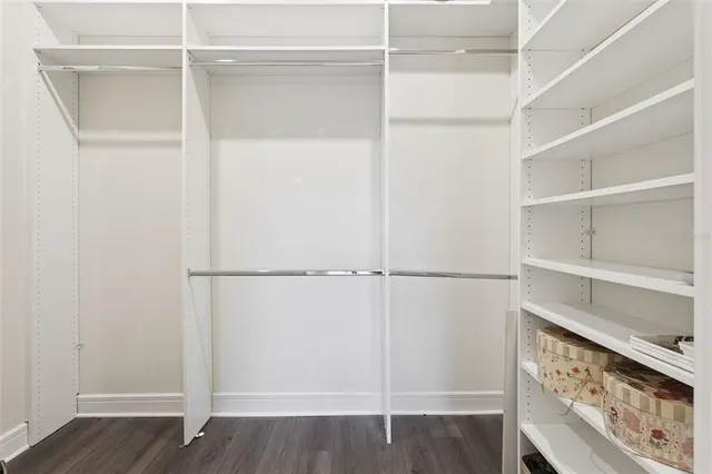 an aerial view of residential houses with outdoor space and lake view
