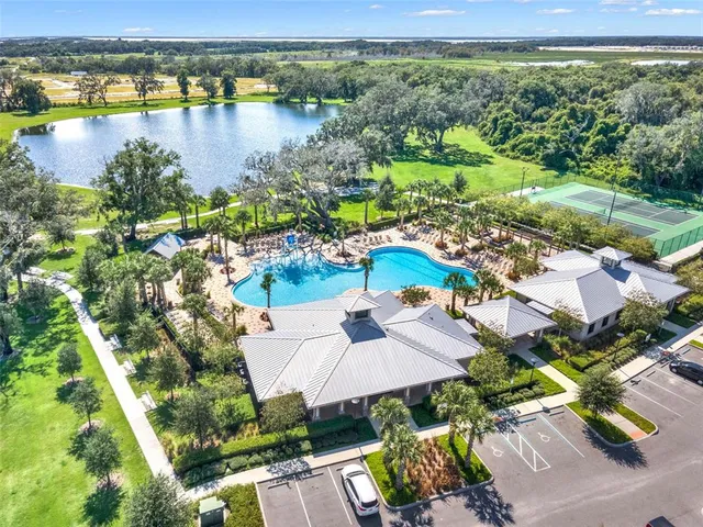 an aerial view of a house with outdoor seating