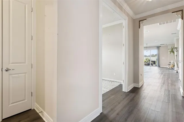 a kitchen with kitchen island granite countertop wooden cabinets and refrigerator