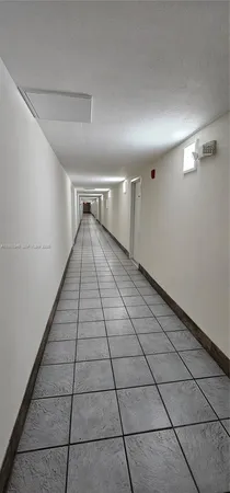 a view of an empty room and wooden floor
