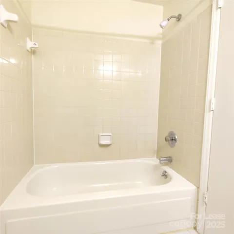 a bathroom with a bathtub and shower