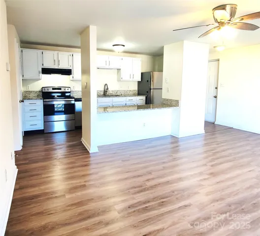 a kitchen with stainless steel appliances a refrigerator and a stove top oven