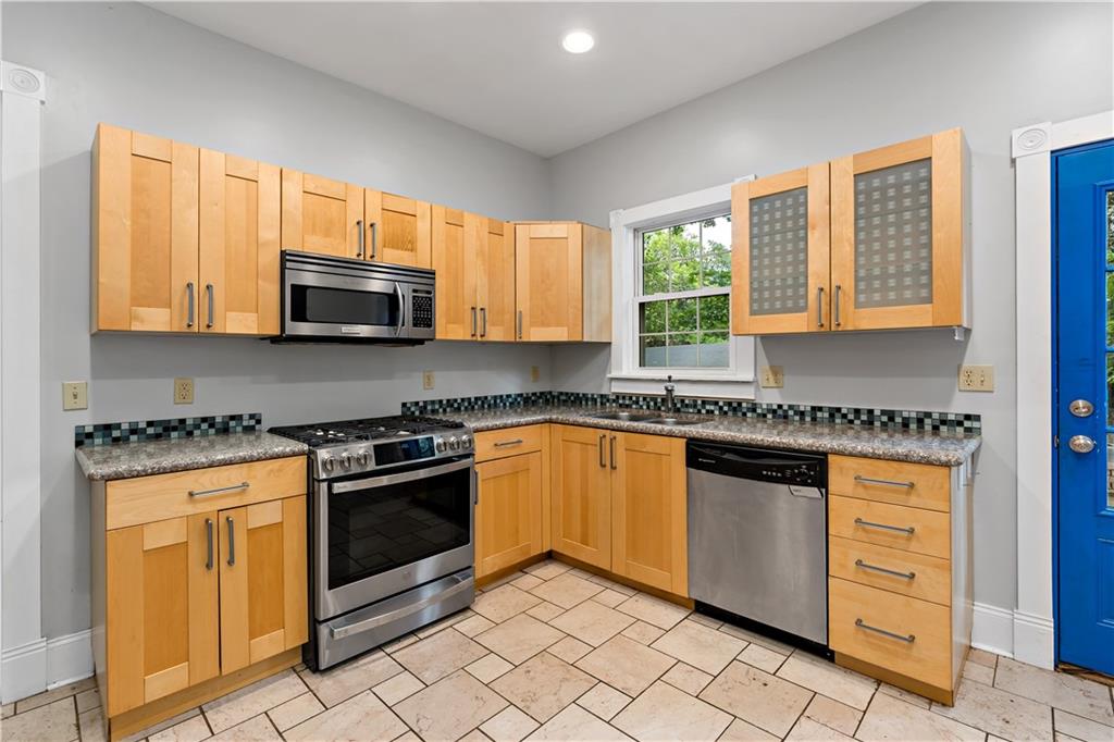 5447 Potter Street Pittsburgh, PA 15232 - Photo 11 of 36 a kitchen with stainless steel appliances granite countertop a stove a sink and a microwave