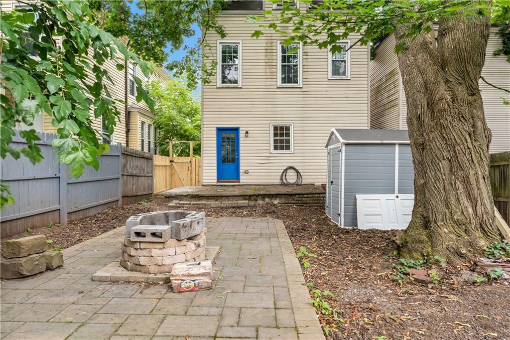 5447 Potter Street Pittsburgh, PA 15232 - Photo 32 of 36 a view of a backyard with table and chairs and wooden fence