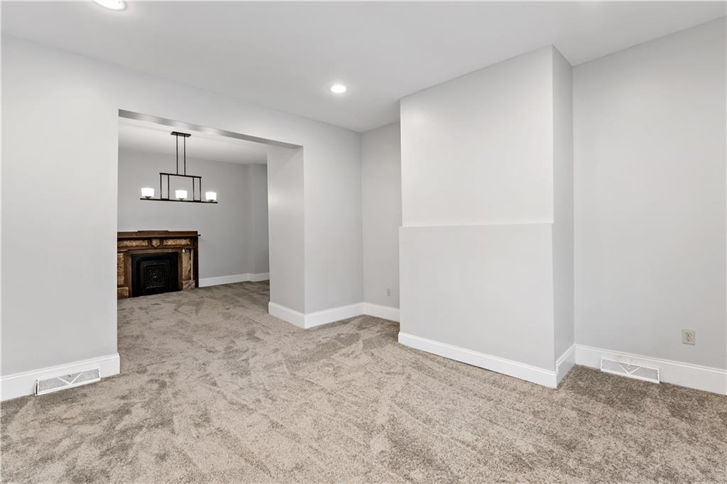 5447 Potter Street Pittsburgh, PA 15232 - Photo 6 of 36 an empty room with a fireplace