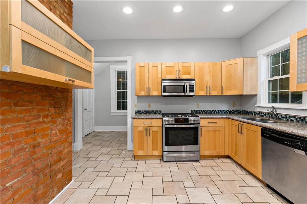 5447 Potter Street Pittsburgh, PA 15232 - Photo 9 of 36 a kitchen with stainless steel appliances granite countertop a stove a sink and a microwave