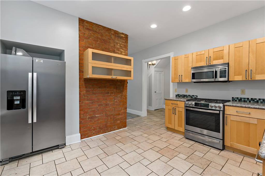 5447 Potter Street Pittsburgh, PA 15232 - Photo 10 of 36 a kitchen with stainless steel appliances granite countertop a refrigerator and a stove