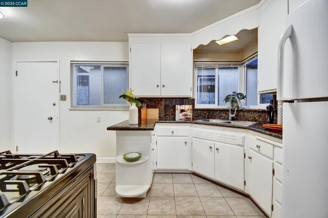 a kitchen with a stove and a refrigerator