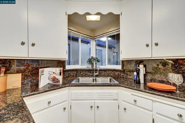 a kitchen with stainless steel appliances granite countertop a sink and cabinets