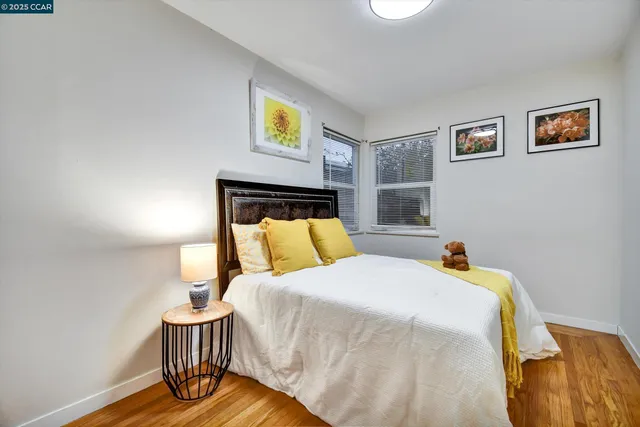 a bedroom with a bed and painting on the wall