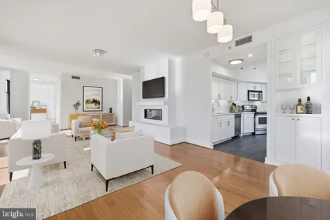 a living room with fireplace furniture and a wooden floor