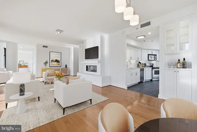 a living room with fireplace furniture and a wooden floor