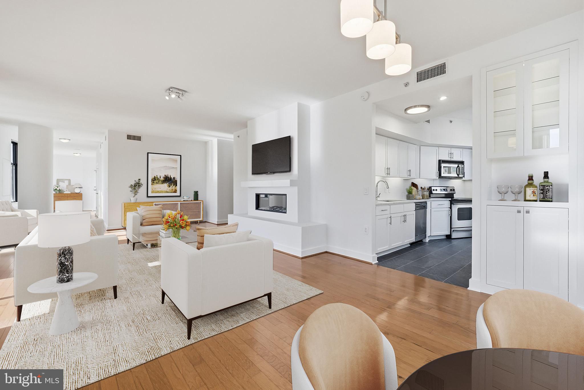 400 Massachusetts Avenue Northwest, Unit 719 Washington, DC 20001 - Photo 15 of 38 a living room with fireplace furniture and a wooden floor
