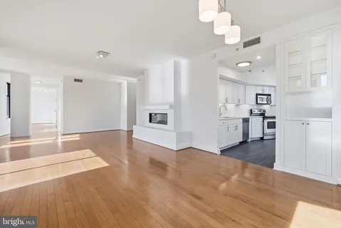 a view of a kitchen with a stove cabinets and wooden floor