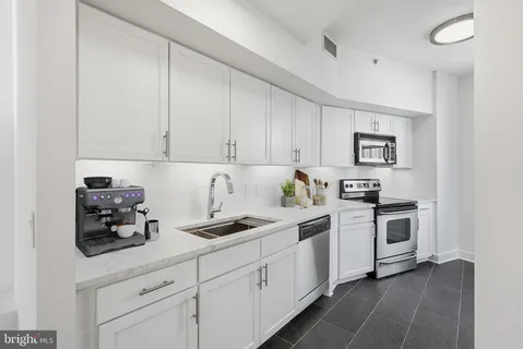 a kitchen with cabinets and white appliances