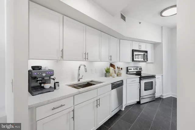 a kitchen with cabinets and white appliances
