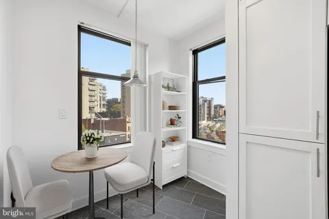 a view of a room with furniture and windows