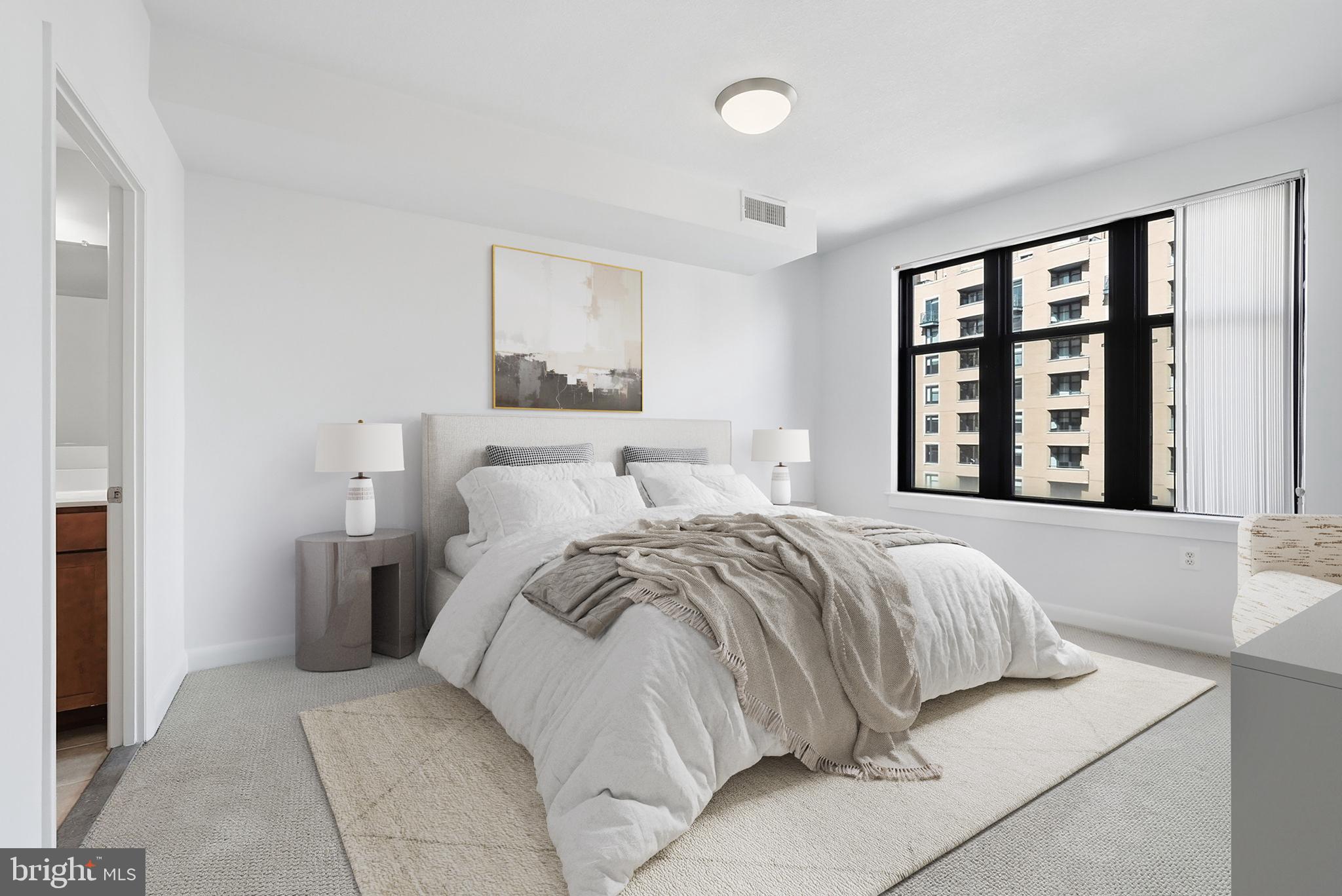 400 Massachusetts Avenue Northwest, Unit 719 Washington, DC 20001 - Photo 22 of 38 a bedroom with a bed and a large window