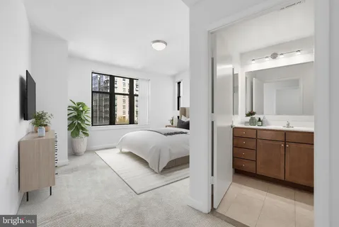 a spacious bedroom with a large bed and a couch