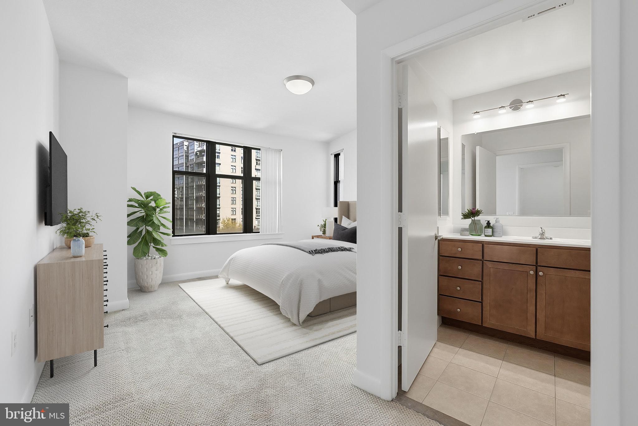 400 Massachusetts Avenue Northwest, Unit 719 Washington, DC 20001 - Photo 26 of 38 a spacious bedroom with a large bed and a couch