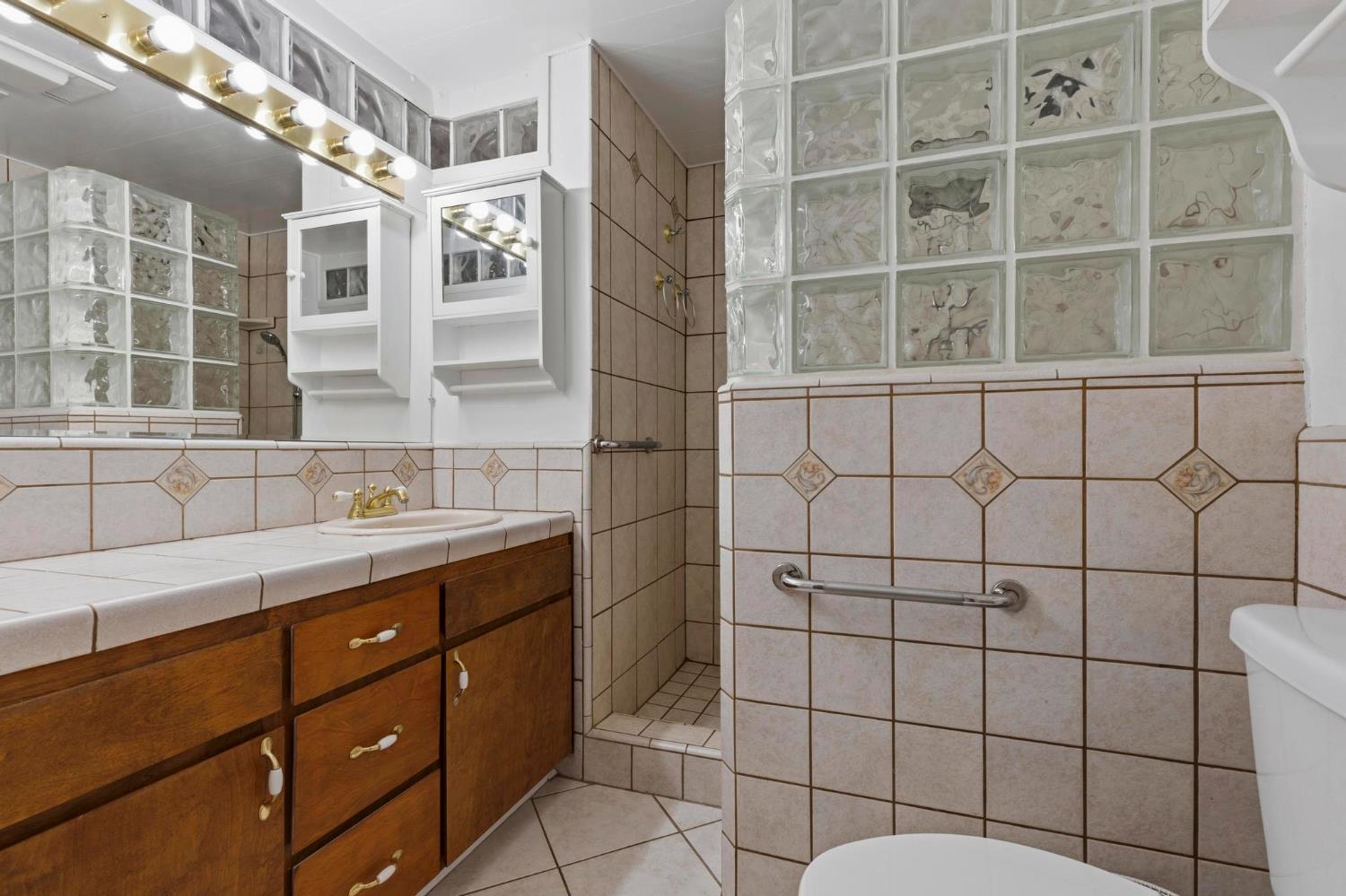 4361 Dresser Road Yuba City, CA 95993 - Photo 16 of 78 a bathroom with a sink toilet and shower