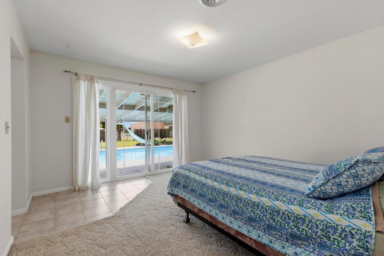 4361 Dresser Road Yuba City, CA 95993 - Photo 20 of 78 a bedroom with a bed and a gate