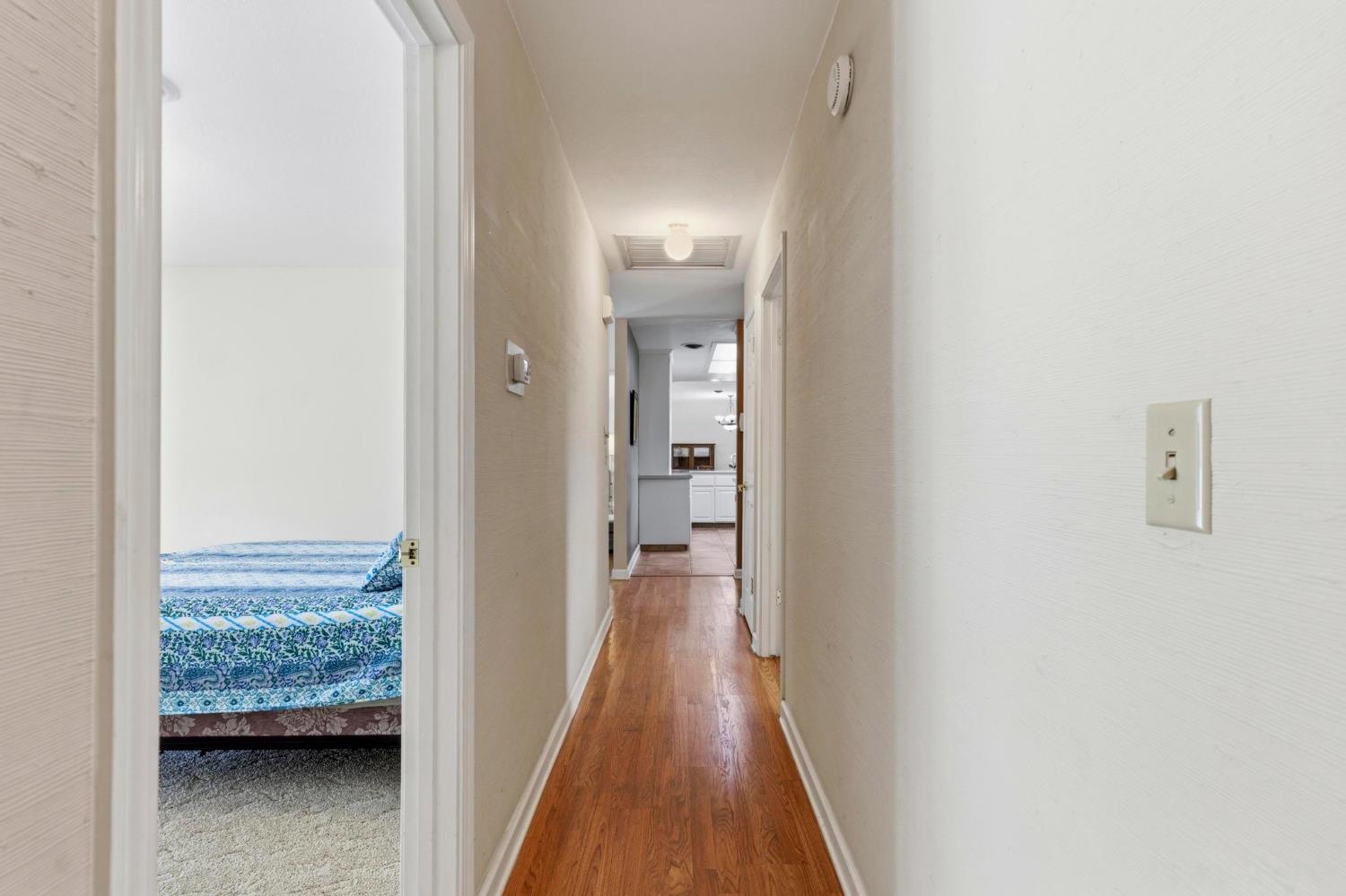 4361 Dresser Road Yuba City, CA 95993 - Photo 26 of 78 a view of a hallway with wooden floor and a bathroom