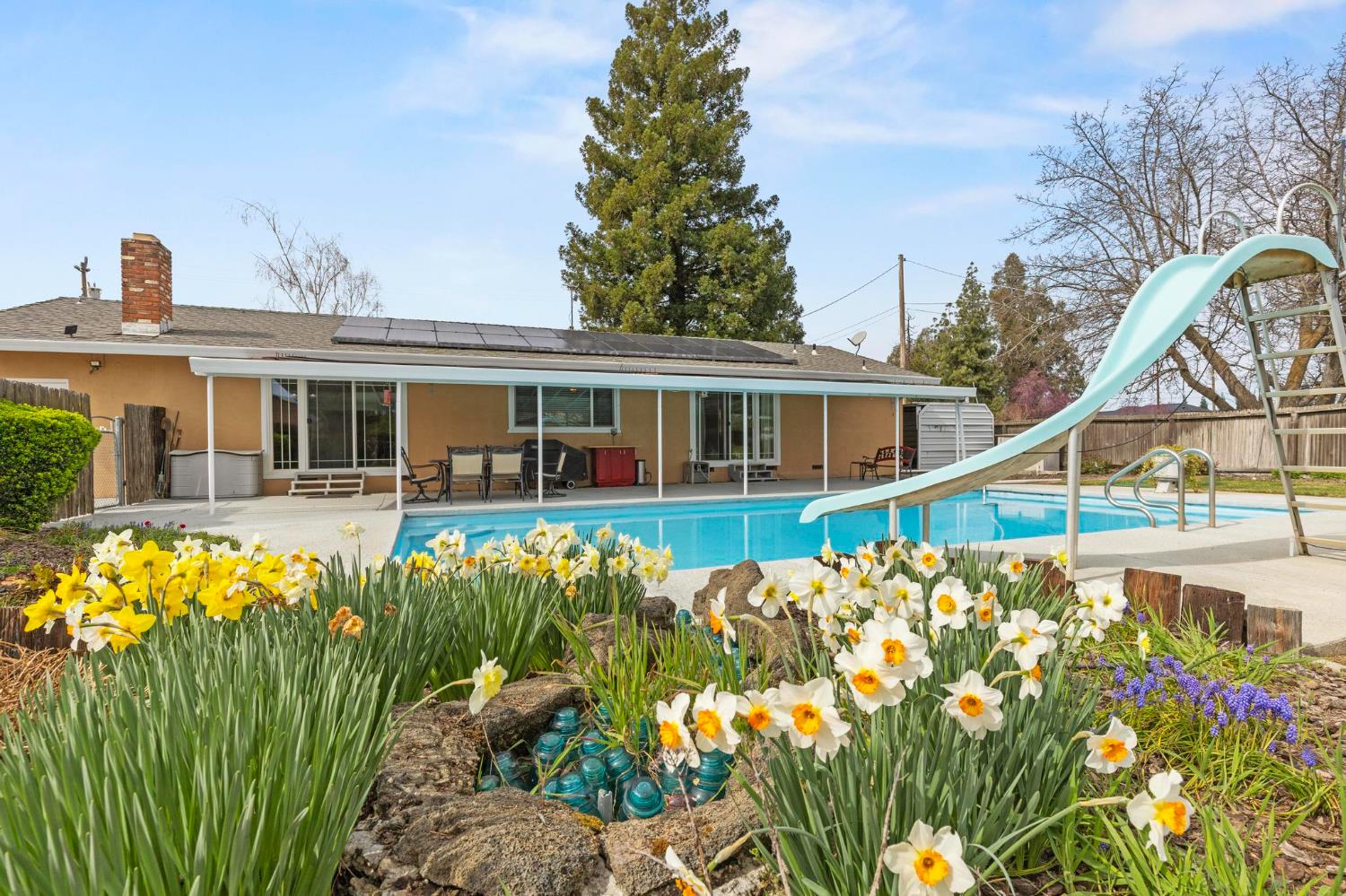 4361 Dresser Road Yuba City, CA 95993 - Photo 33 of 78 a front view of a house with a garden and swimming pool