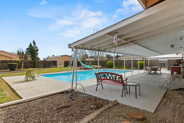 a view of a backyard with a garden and deck