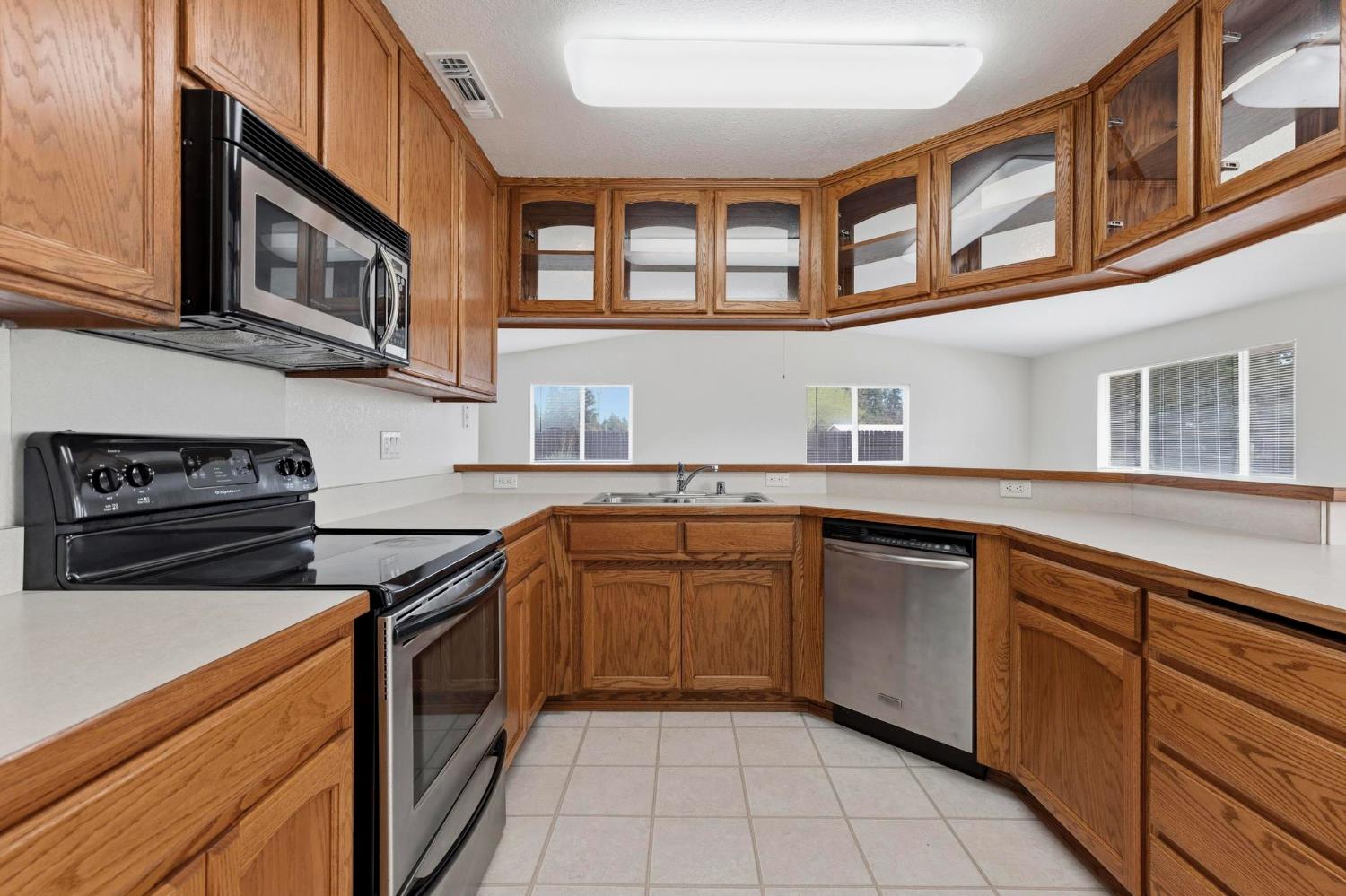 4361 Dresser Road Yuba City, CA 95993 - Photo 45 of 78 a kitchen with stainless steel appliances granite countertop a stove and a sink