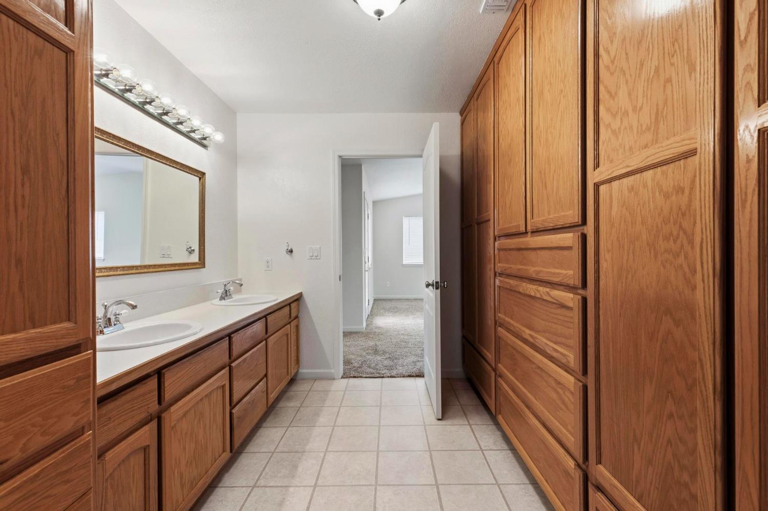 4361 Dresser Road Yuba City, CA 95993 - Photo 51 of 78 a bathroom with a double vanity sink and a mirror