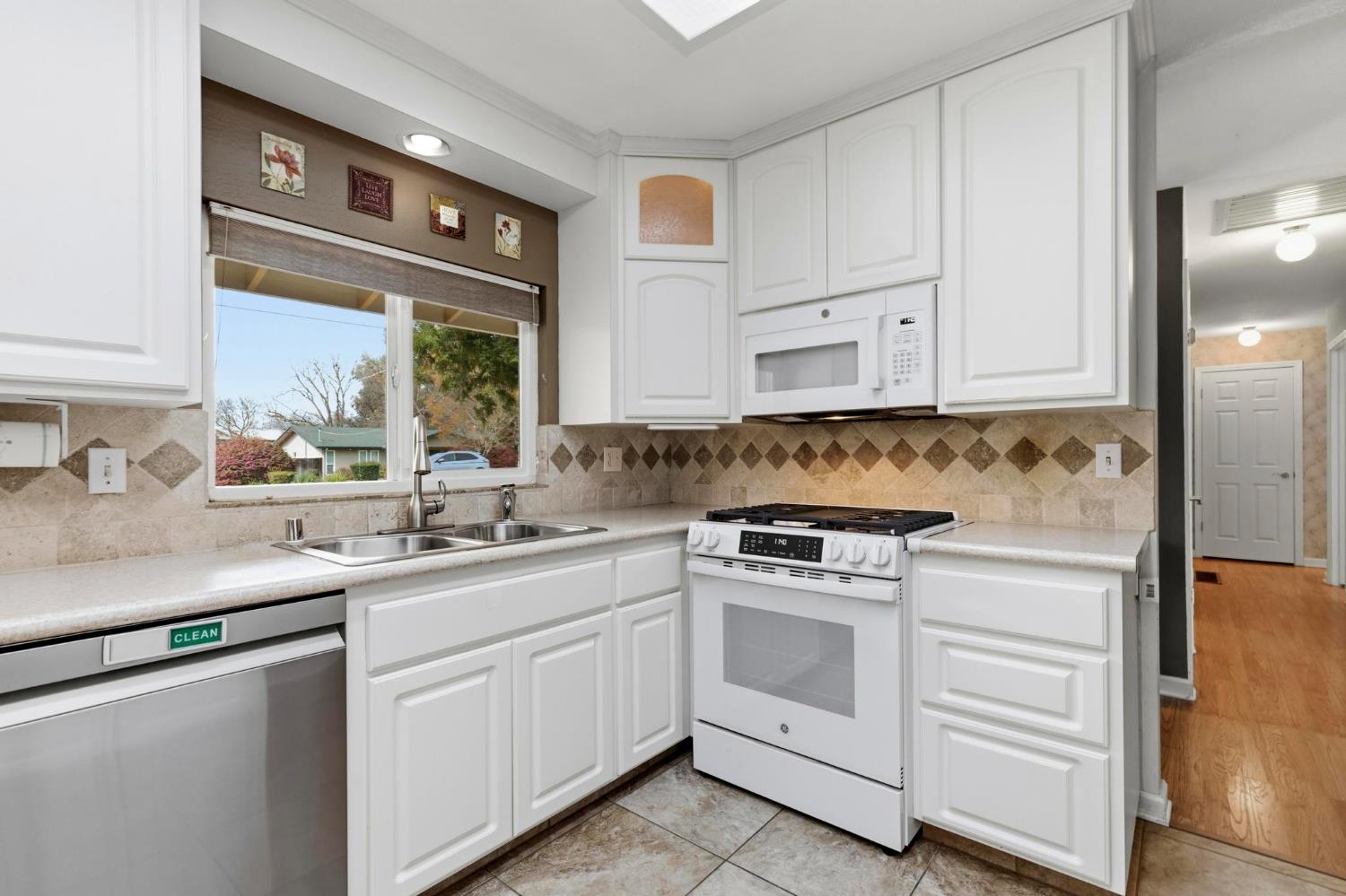 4361 Dresser Road Yuba City, CA 95993 - Photo 8 of 78 a kitchen with white cabinets and white appliances