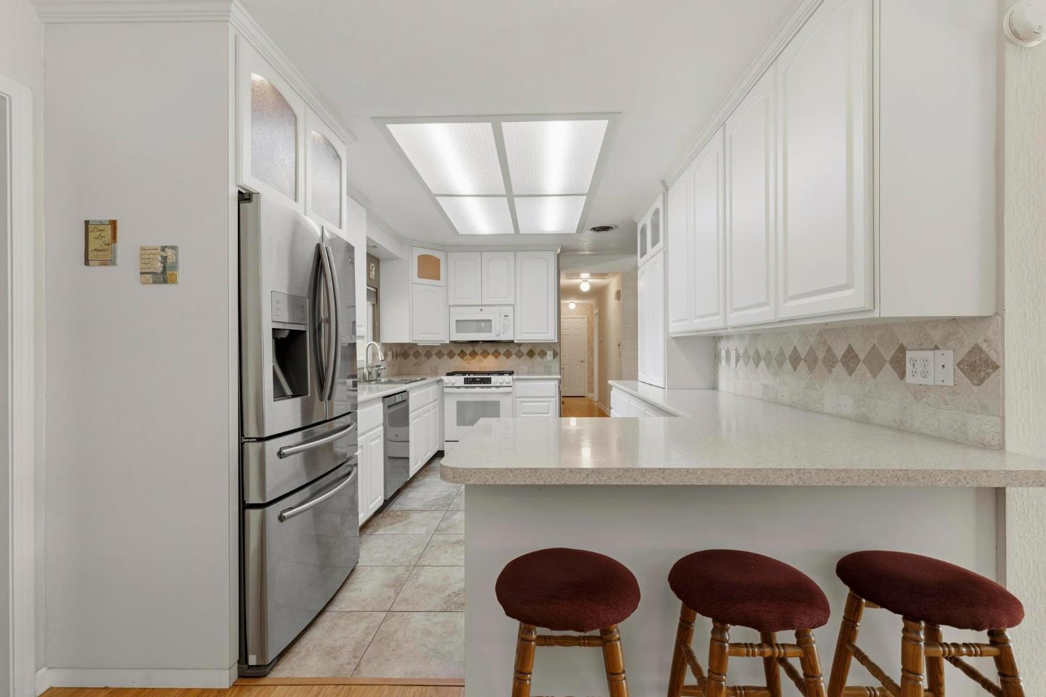 4361 Dresser Road Yuba City, CA 95993 - Photo 9 of 78 a kitchen with stainless steel appliances a refrigerator a stove a sink and a refrigerator