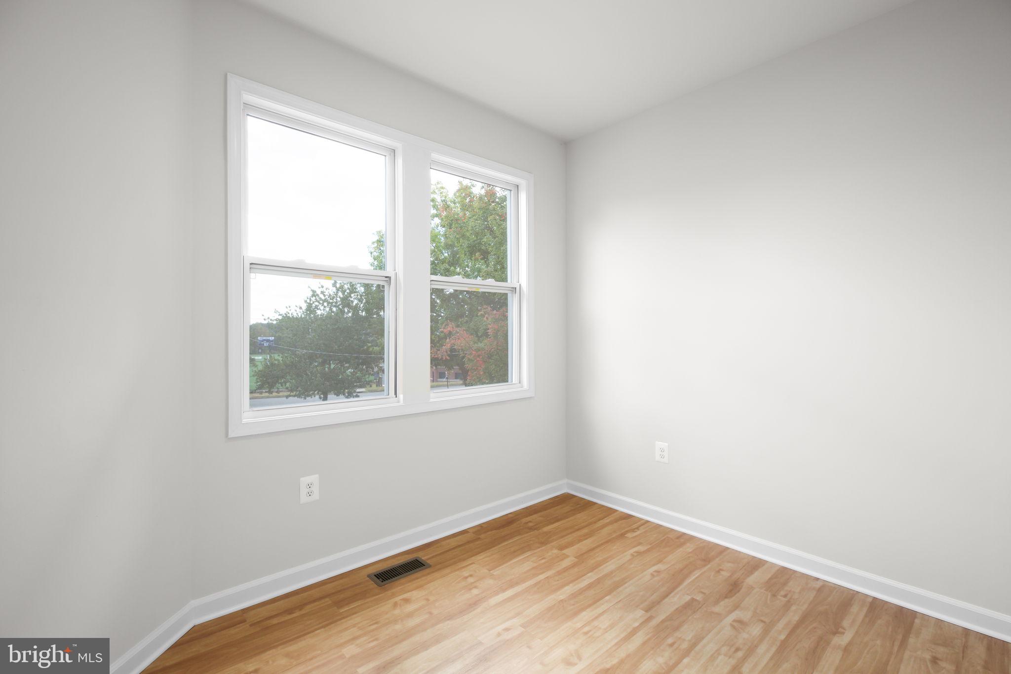 1424 William Street, Unit A Fredericksburg, VA 22401 - Photo 15 of 25 a view of an empty room with wooden floor and a window