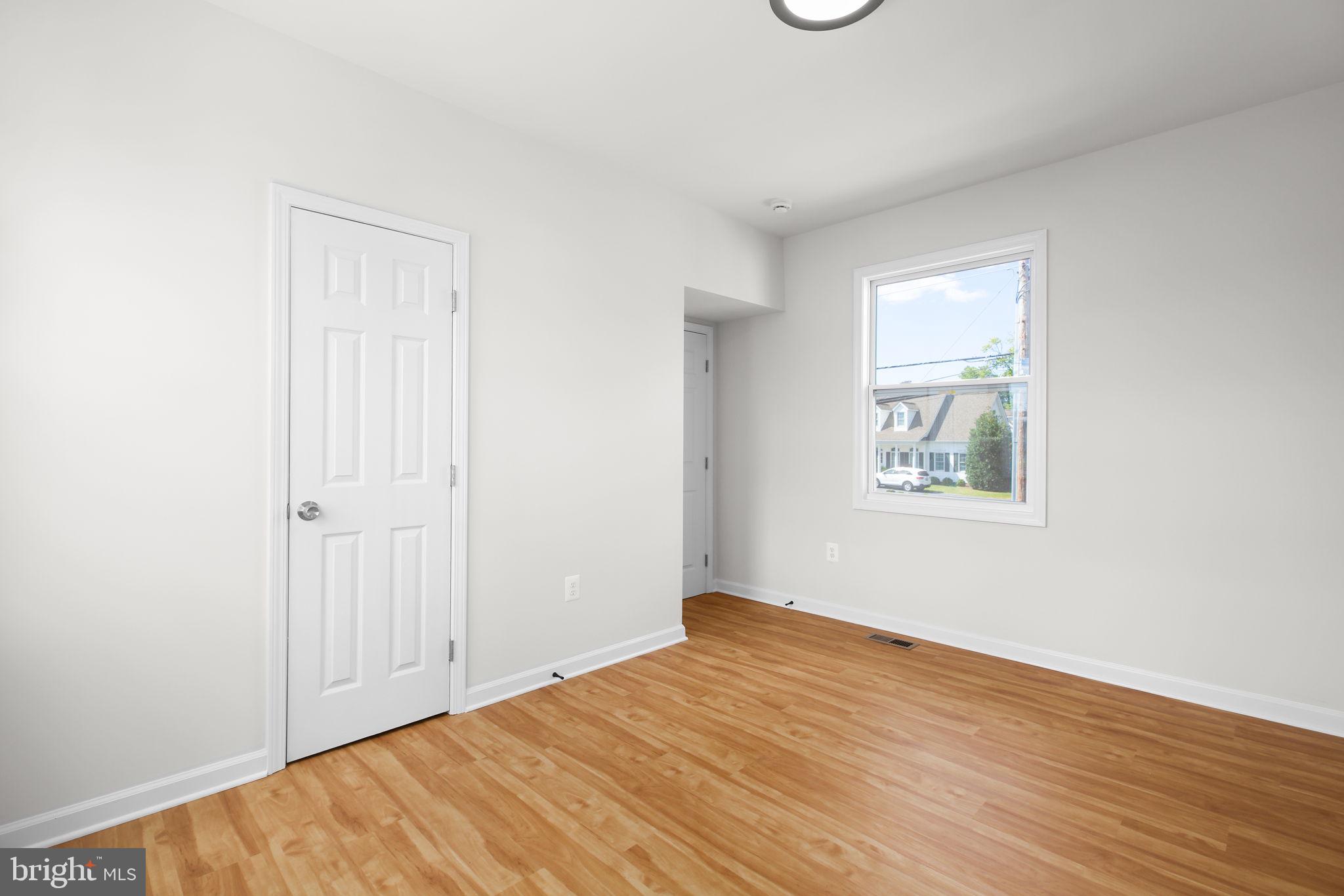 1424 William Street, Unit A Fredericksburg, VA 22401 - Photo 20 of 25 an empty room with wooden floor and windows