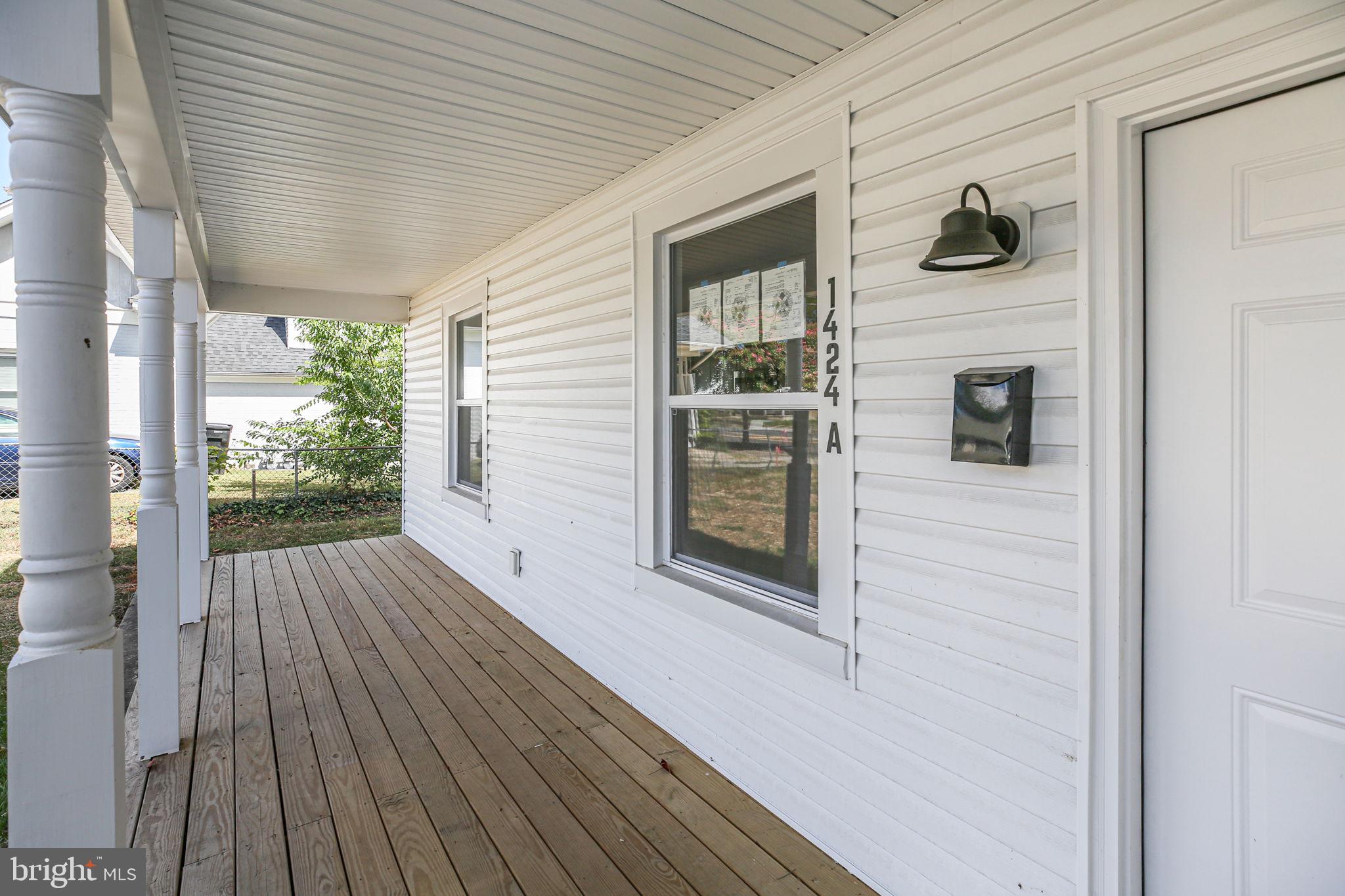 1424 William Street, Unit A Fredericksburg, VA 22401 - Photo 2 of 25 a porch with wooden floor and outdoor space