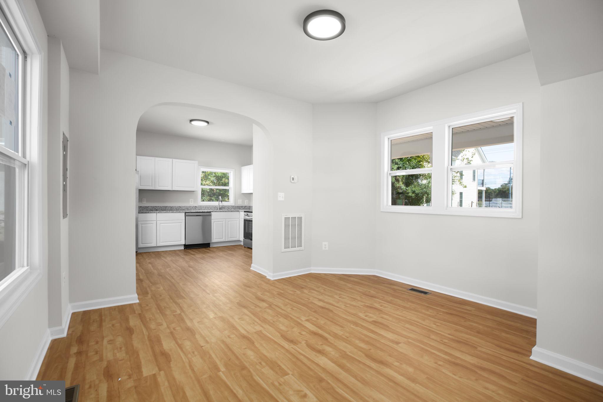 1424 William Street, Unit A Fredericksburg, VA 22401 - Photo 3 of 25 wooden floor in an empty room with a window