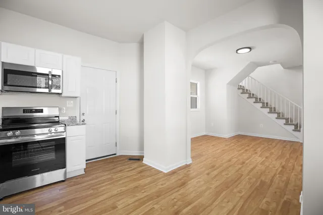 a view of kitchen with sink and stainless steel appliances