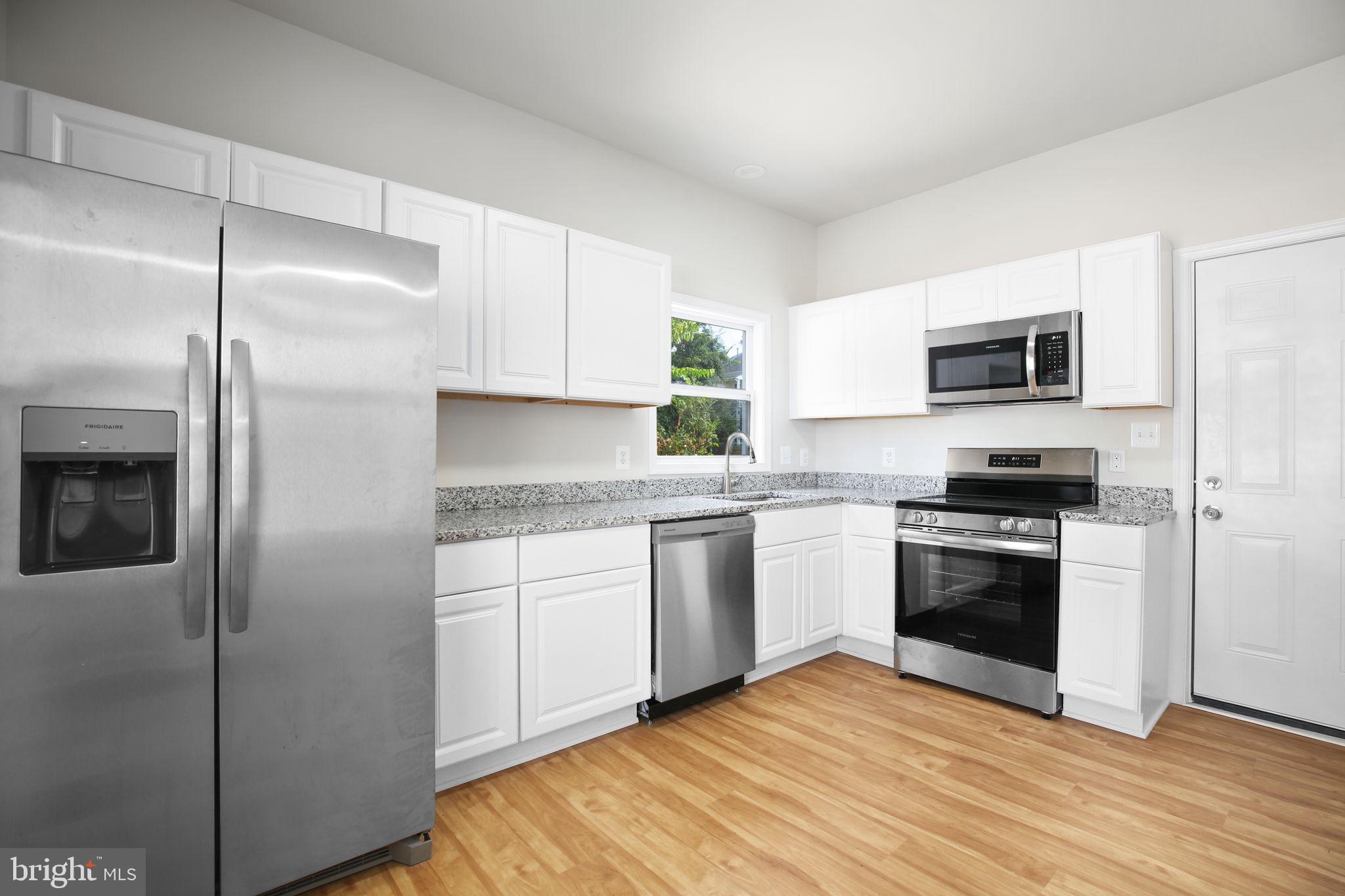 1424 William Street, Unit A Fredericksburg, VA 22401 - Photo 9 of 25 a kitchen with a refrigerator stove and microwave
