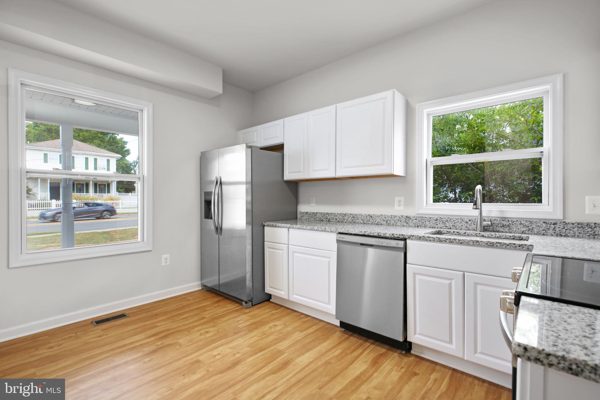 1424 William Street, Unit A Fredericksburg, VA 22401 - Photo 10 of 25 a kitchen with granite countertop wooden floors and wide window