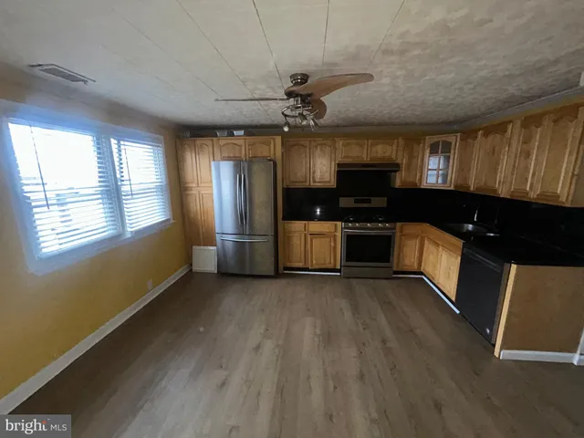 a view of a kitchen with a sink microwave and stove top oven