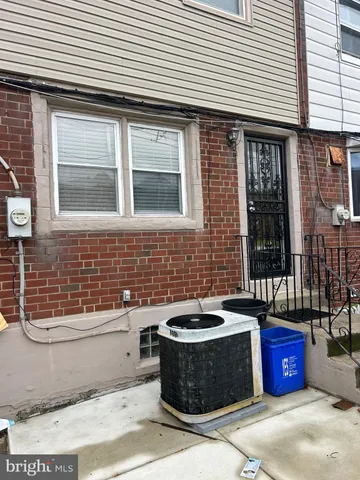a view of a brick house with a bench