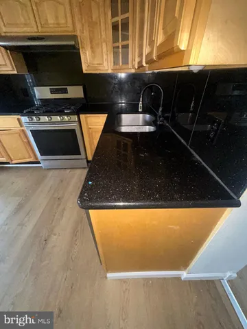 a view of kitchen island with granite countertop lots of appliances