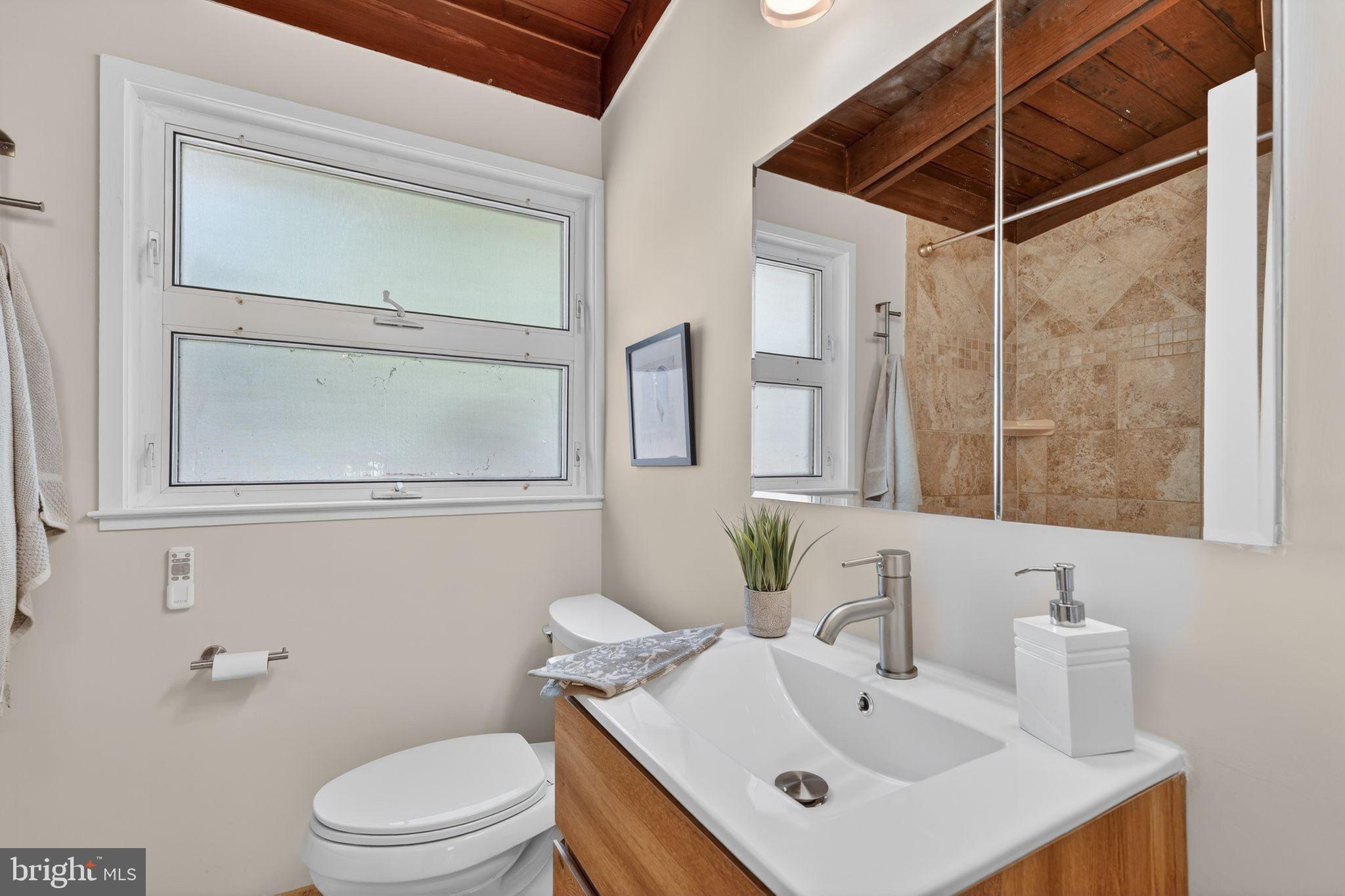 2931 Pine Spring Road Falls Church, VA 22042 - Photo 14 of 25 a bathroom with a sink mirror toilet and vanity