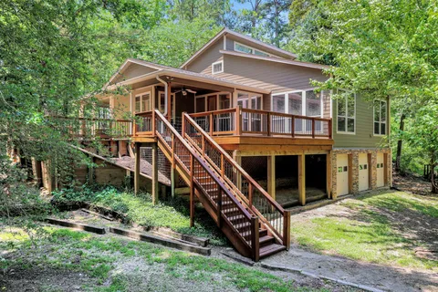 a front view of a house with a yard and balcony
