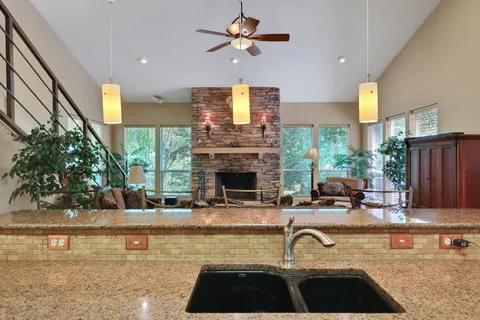 a kitchen with a sink and a stove top oven