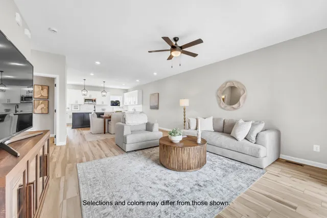 a living room with furniture and a view of kitchen
