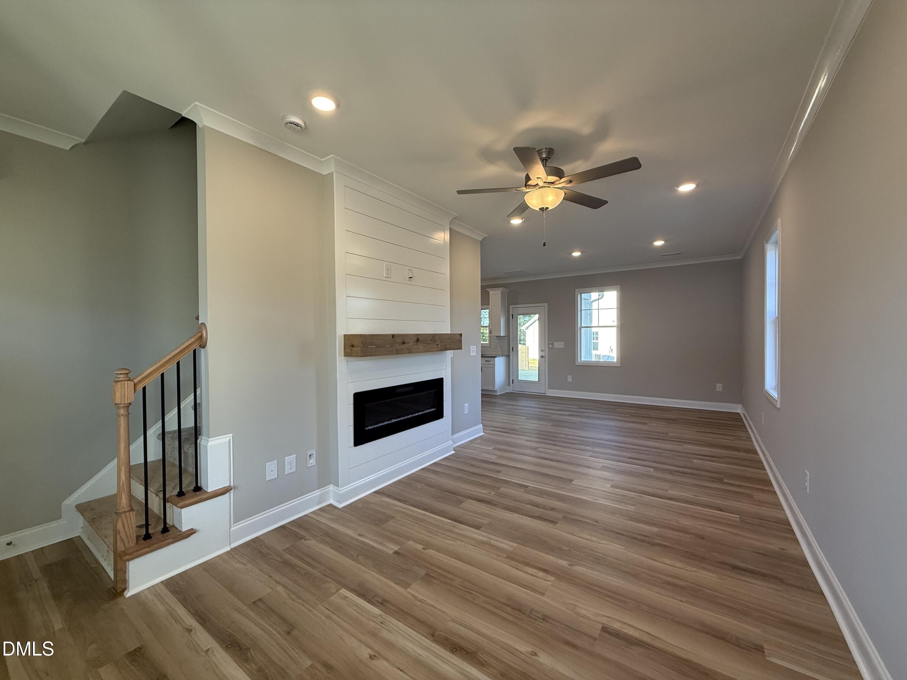 263 Bluejay Street Clayton, NC 27520 - Photo 7 of 22 a view of an empty room with wooden floor fireplace and a window