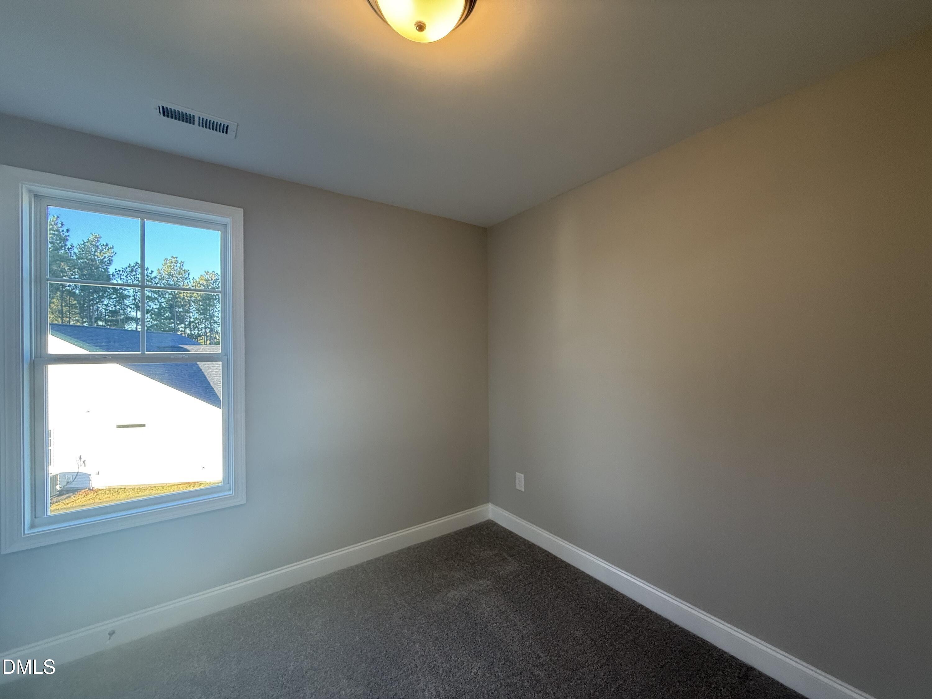 263 Bluejay Street Clayton, NC 27520 - Photo 10 of 22 an empty room with a window
